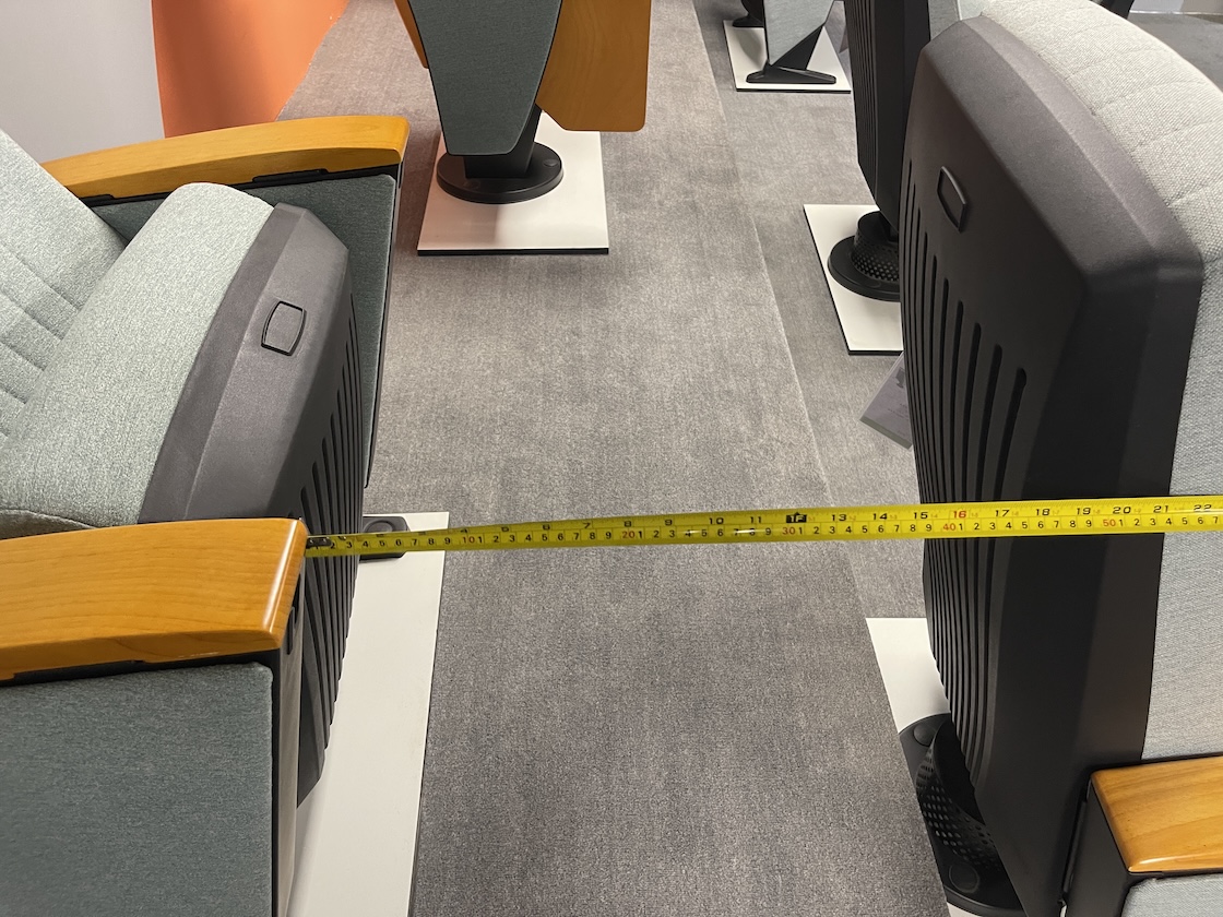 Measuring row spacing between auditorium chairs according to JGJ57-2016 standard